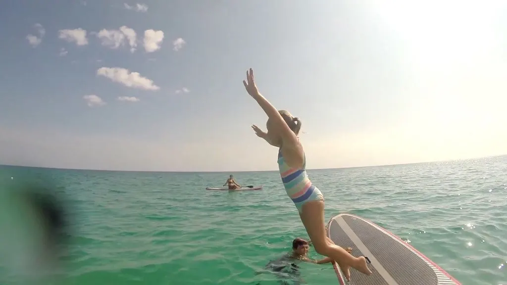 Paddle Boarding in Destin Florida - Mattie Jumping Off Board