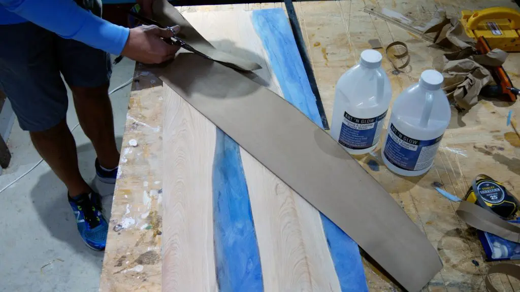 how to make wood and resin wall art that glows_cut out surfboard template with scissors