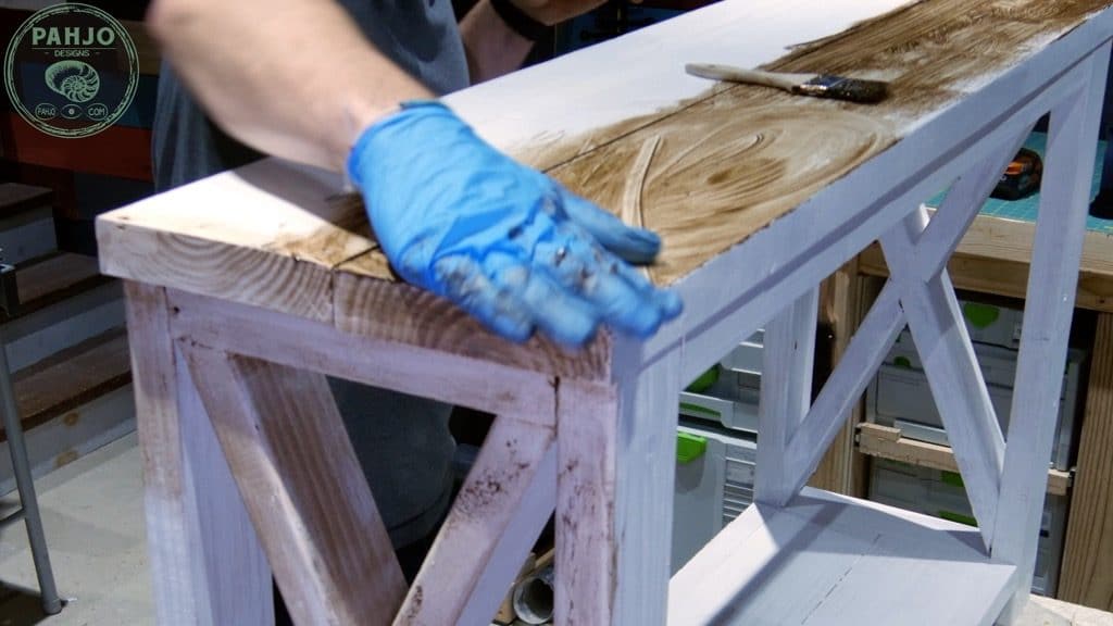 use hand to apply dark creme wax to distress painted furniture