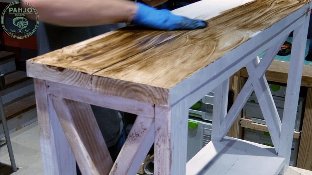 use hand to apply dark creme wax to distress painted furniture